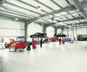 Large working automotive repair facility with a beautiful white high gloss commercial epoxy flooring.