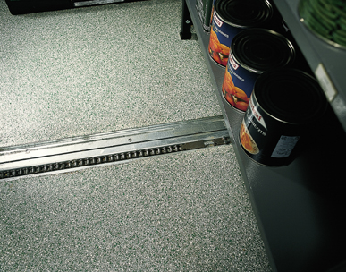 a finished trench drain system expertly installed with seamless epoxy flooring surrounding