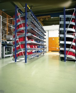 Large warehouse with storage racks and a monolithic flooring depicted.