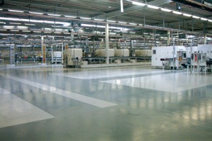 Large factory seal coating flooring system shines beneath the light.