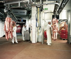 Workers in a meet distribution plant work diligently over a strong bonded floor.