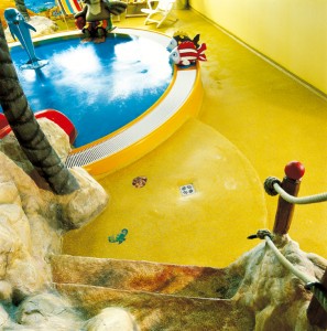 Concrete floor colors bring replicated pond to life in this child play area.