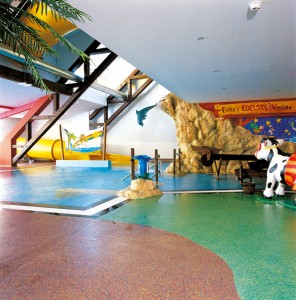 Concrete floor colors bring to life interior play area for children.