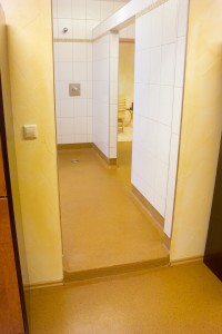 Entry to shower room displays new waterproof membrane give slip resistance to patrons.