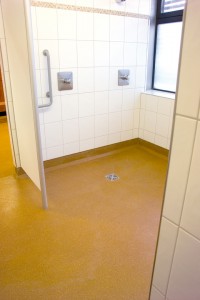 Newly installed shower floor waterproof membrane brightens excercise facility shower room.