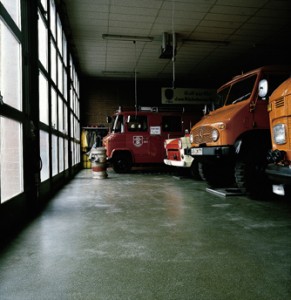 Industrial garage houses numerous vehicles showing the quality in the concrete floor strength within.