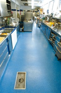 A commercial kitchen displays its new flooring for concrete slab in a beautiful blue tone.