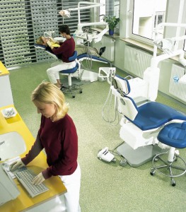 Assistant prepares a patient for dental work with confidence knowing her new hygienic floor coating is doing its job.