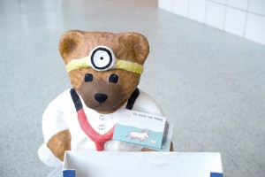 A small teddy bear rests atop new pharmaceutical flooring as a reminder of the importance of flooring protection.