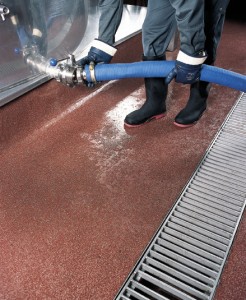 A water barrier floor protects this floor system from any spilling of the holding tank while this worker connects an extracting hose.