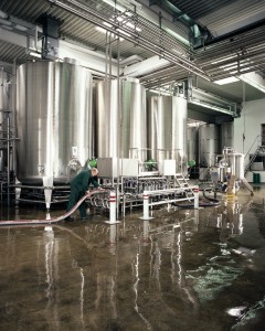 A large factory plant floor sparkles clean with a new concrete floor coating material recently installed.