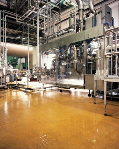 A mustard hue floor coating material lightens this production factory concrete floor system.