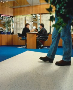 Office worker walks confidently across a no slip condition flooring system.