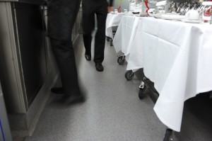 A clear floor coating for no slip resistance protects these waiters and waitresses from fall harm.