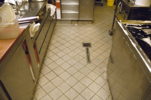 An old kitchen tile floor is scheduled for over night resurfacing.