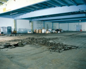 A severly damaged warehouse floor slab get prepared for a top coat liquid floor leveling compound.