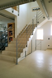 Concrete staircases for industrial and commercial use require a poured floor system for superior protection such as this L shaped stairway.