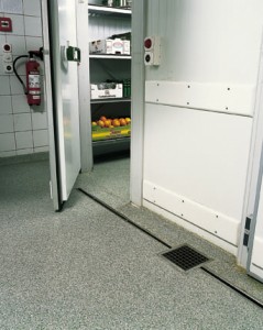 Freezers walked in flooring seamlessly transitions this space from kitchen area to freezer floor area.