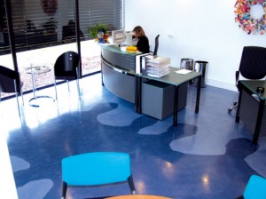 Industrial flooring ideas created this eclectic light and dark blue floor design located in an office foyer.