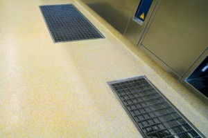 Finished yellow flooring seamlessly blends with two inset floor drain systems.