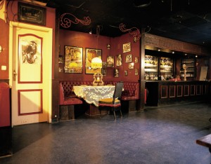 Restaurant building depicts table for two atop grey colored commercial flooring system.