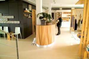 Patron stands atop tan commercial floor system while using service counter.