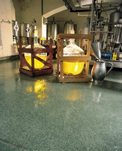 Chemical resisting epoxies reflex golden yellow color from filled containers sitting on new floor coat.