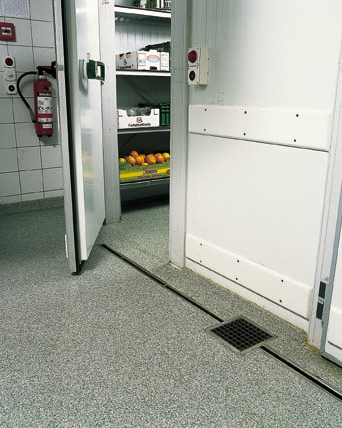 Freezer door open showing floor in walk in freezer room