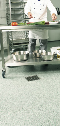 Chef Preparing Food While Standing On Franchise Kitchen Flooring.