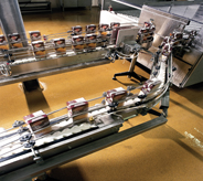 Products fly by on machine on top of assembly line flooring.