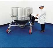 Inspector fills forms after inspecting chemical mixer resting atop blue resistant flooring