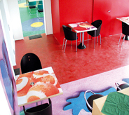 Concrete sealer brightens colored floor decals in posh cafe setting.