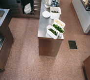 Orange flaked commercialed floor system protects kitchen prep area.
