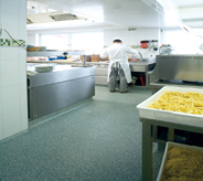 Commercially designed kitchenette flooring protects against harm for working prep cook.