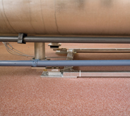 Covered flooring system surrounds industrial concrete equipment.