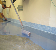 A blue concreted resurface coating is applied with special floor rolling applicator.
