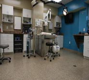 Medical equipment sits on top of a flake floor in this doctor's office.