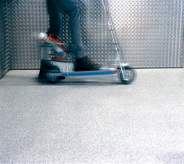 A kick and go trolly cart briskly moves across areas of covered flooring showing zero high traffic wear.