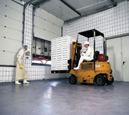 Driver operates forklift across impact resistant floor.