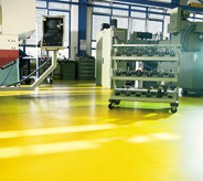 Bright yellow concreted floor seal protects industrial tools.