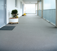 Outdoored industry flooring protects long exterior walkway of hotel.