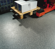 A loaded red pallet jack glides across a no skid flooring surface.