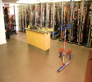Ski shop displays assorted skis's atop gorgious earth toned commercial seamless floor.