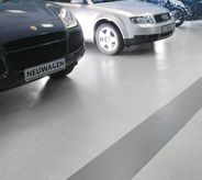 Cars parked on showroom flooring.