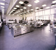 Blue acrylic floor seal iluminates large kitchen area.