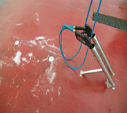 Pressure washer rests atop red anti slip floor coat system.