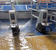 Automated pressure wash machine cleans anti slip floor coating.