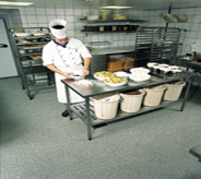 Stainless steel kitchen area sits atop antibacterial flooring system.