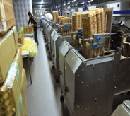 Worker moves about assembly line flooring.