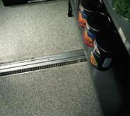 Grey system flooring protects concrete in storage room area.